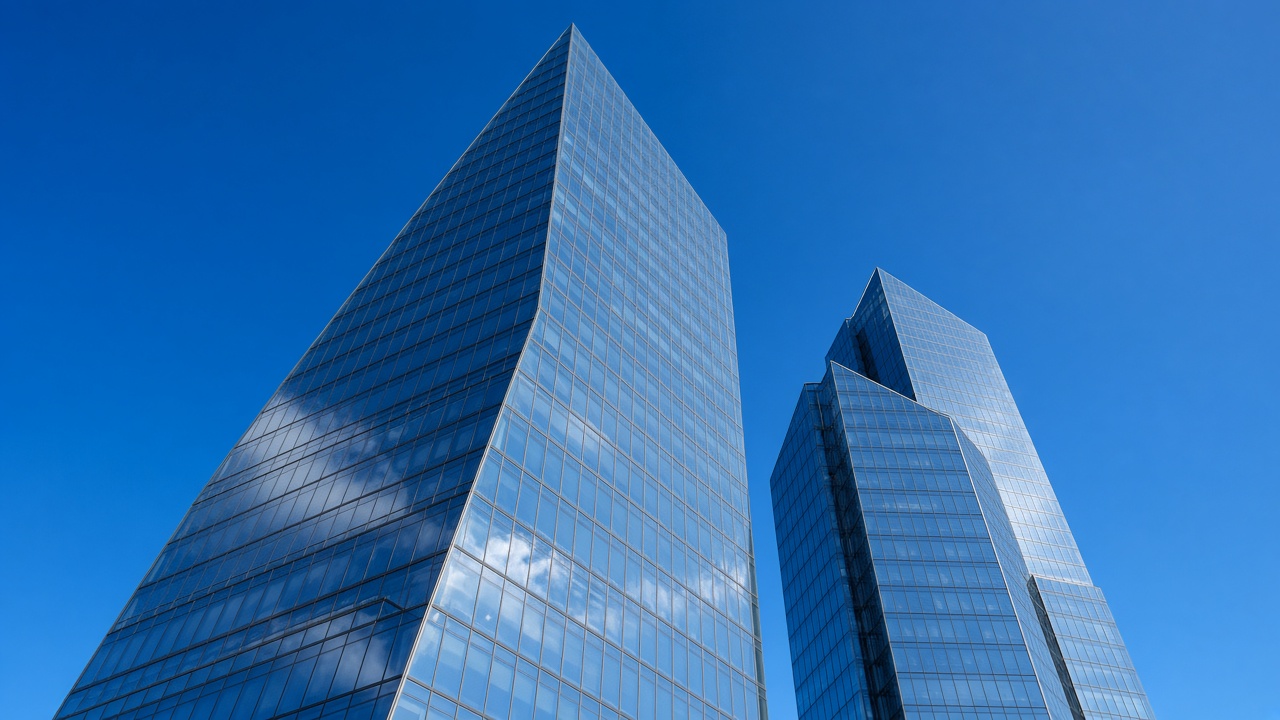Glass office towers against a clear sky